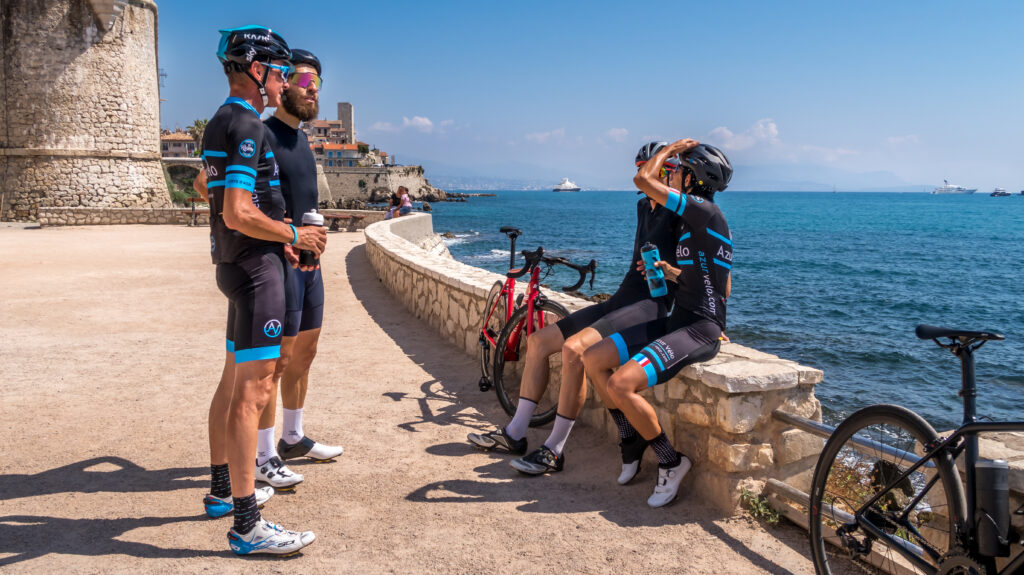 Cyclists Resting on a Sea Wall and Talking One