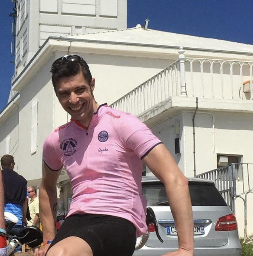 A Cyclist in Pink Color Shirt and Black Shorts