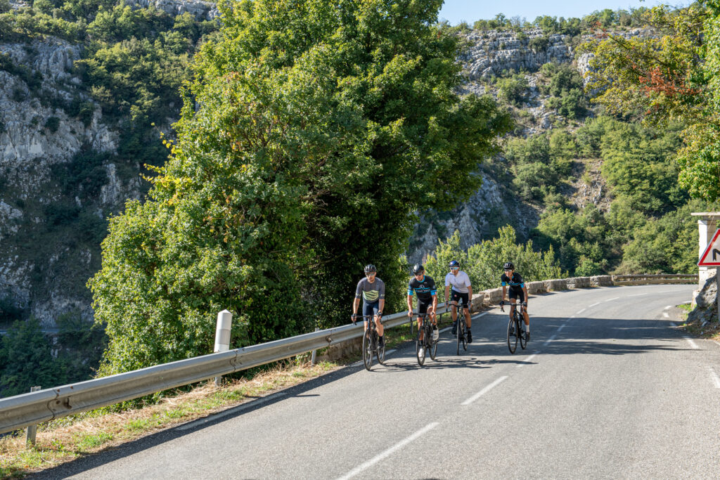 Three Cyclists Cycling on the Mountain Side
