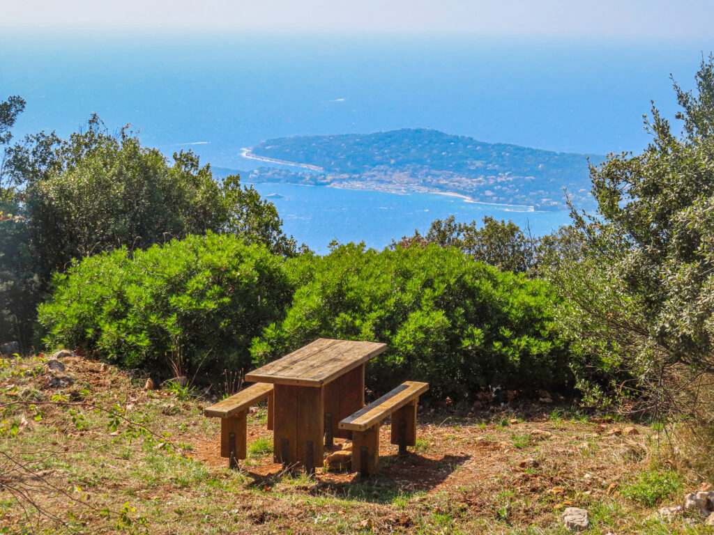 Wooden picnic table overlooking coastal island